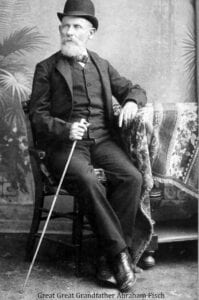 A man sitting in a chair holding a cane.