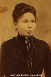 A woman in black dress and necklace.