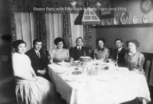 A group of people sitting at a table with food.