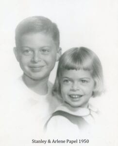 A young boy and girl pose for the camera.