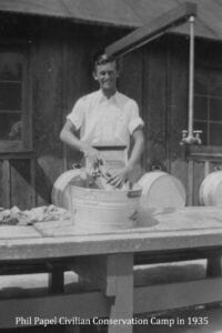 A man standing in front of a table with many baskets.