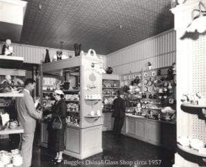 A black and white photo of people in a store.