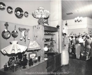 A group of people standing around in an old store.