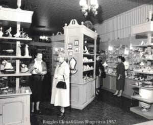 A group of people standing in front of a store.