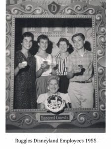 A group of people holding wine glasses in front of a picture.