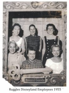 A group of people standing in front of a brick wall.