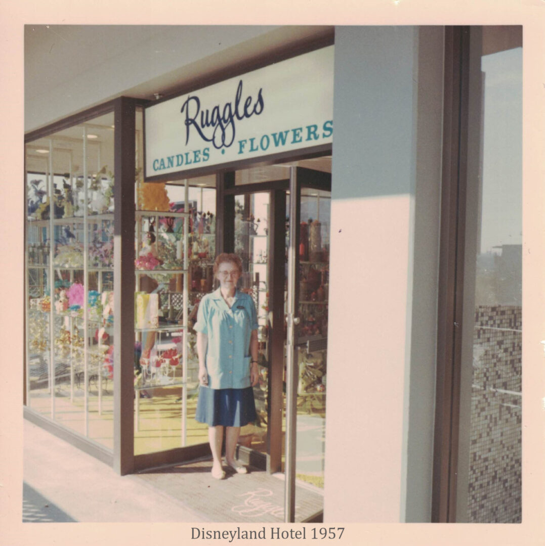 A man standing in front of a store window.